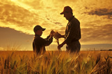 Father and son in a maturing barley field